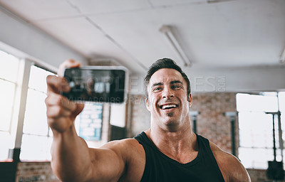 Buy stock photo Cropped shot of a young man taking a selfie at the gym