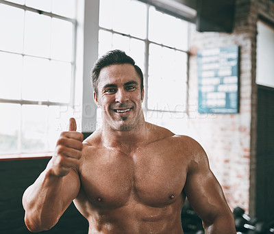 Buy stock photo Shot of a man showing thumbs up at the gym