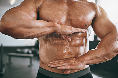 Buy stock photo Cropped shot of a man framing his stomach with his hands