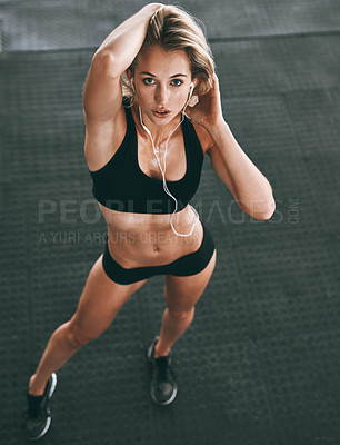 Buy stock photo Hight angle shot of a sporty young woman posing in gym