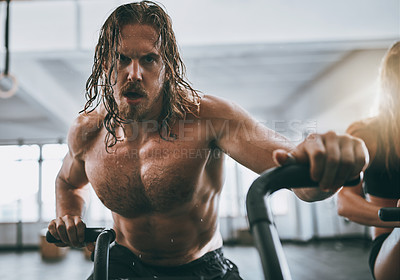 Buy stock photo Cropped shot of a man working out on a elliptical machine