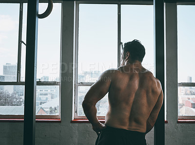 Buy stock photo Rearview shot of a muscular man after his workout
