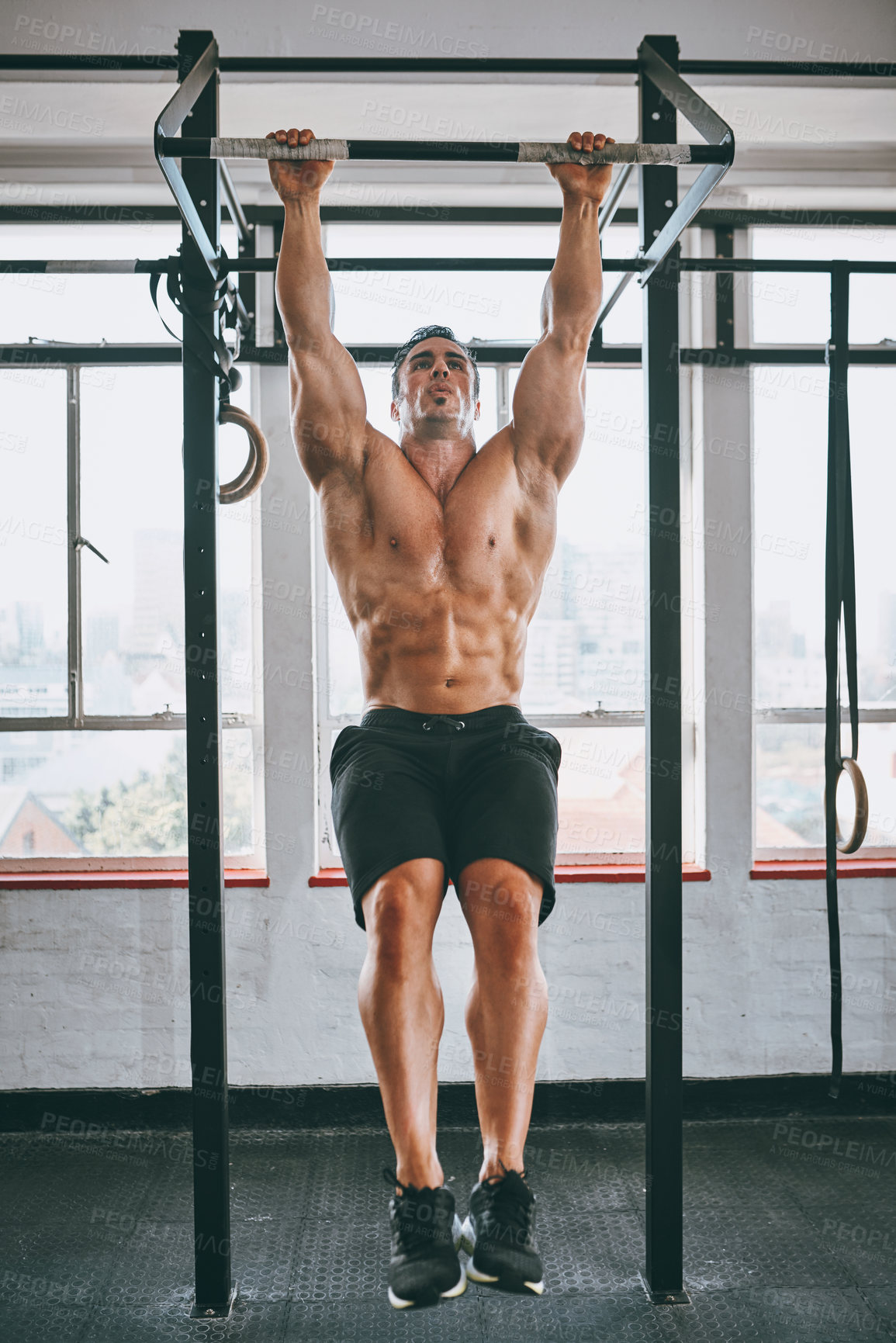 Buy stock photo Shot of a muscular man working out in a gym