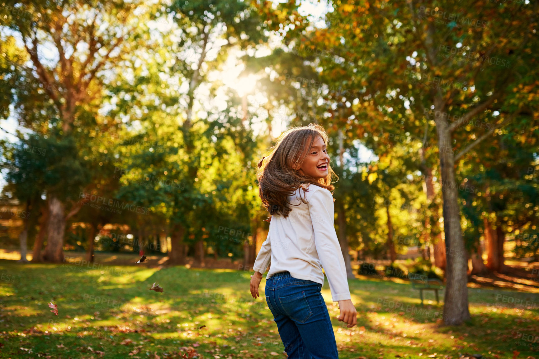 Buy stock photo Shot of a happy little girl playing in the autumn leaves outdoors