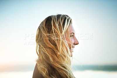Buy stock photo Cropped shot of an attractive young female surfer standing on the beach