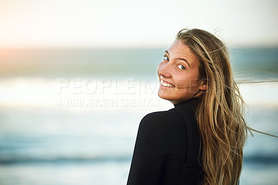 Buy stock photo Rearview portrait of an attractive young female surfer standing on the beach