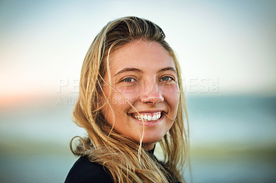Buy stock photo Cropped portrait of an attractive young female surfer standing on the beach