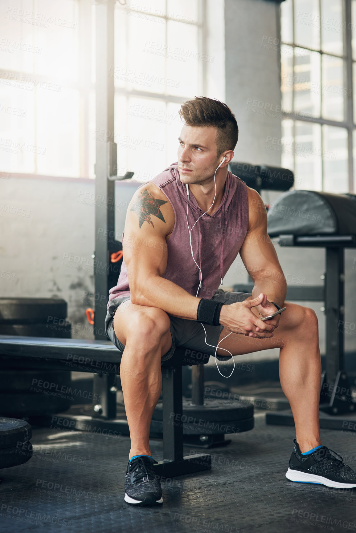 Buy stock photo Shot of a handsome young man at the gym