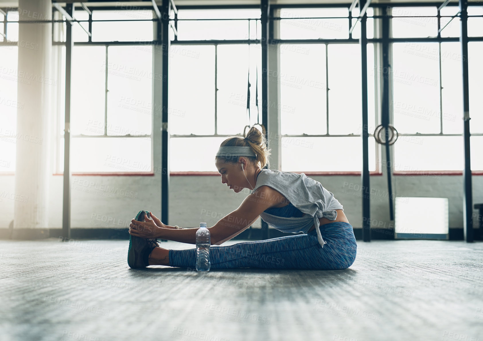 Buy stock photo Exercise, legs and stretching with woman on floor of gym for health, improvement or wellness. Fitness, training and warm up for workout with athlete getting ready for physical improvement routine