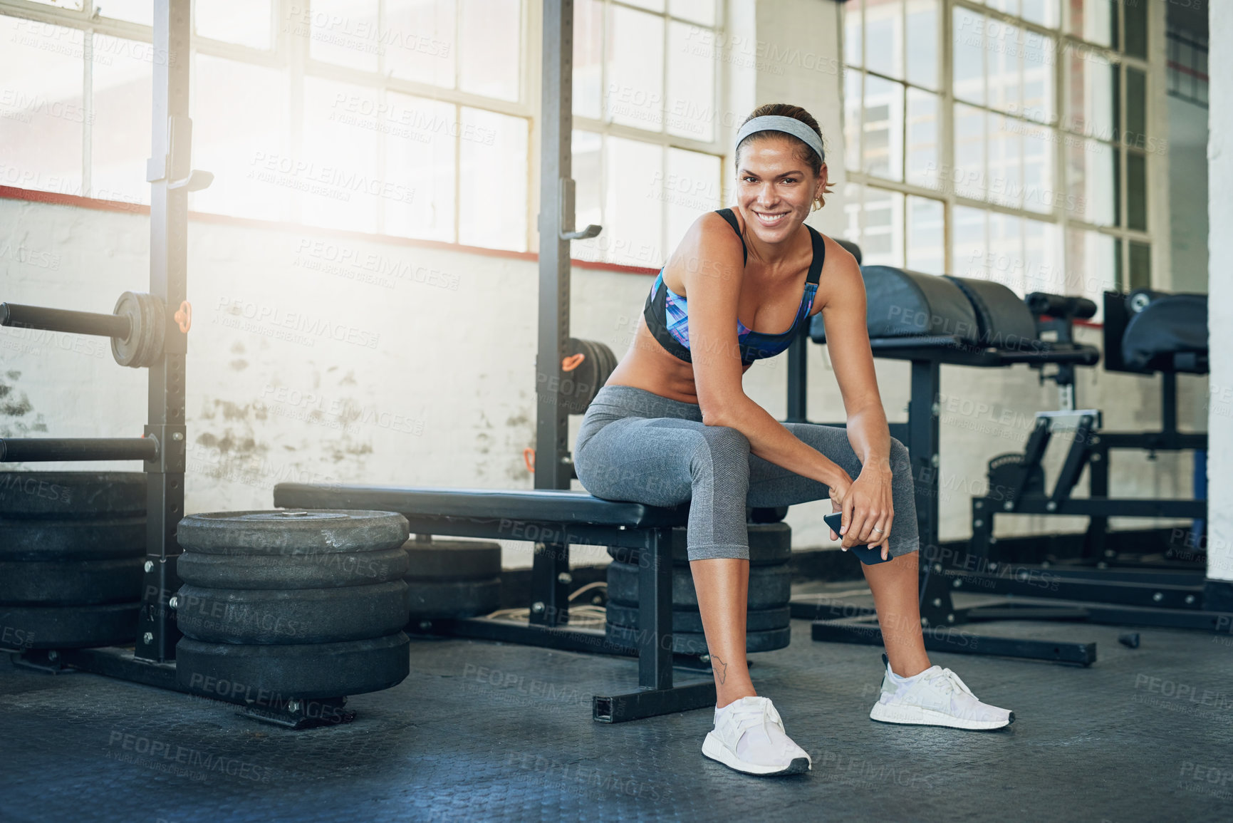 Buy stock photo Shot of a young attractive woman working out in a gym