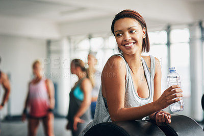 Buy stock photo Shot of a young attractive woman working out in a gym