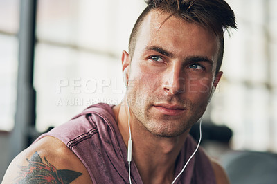 Buy stock photo Shot of a handsome young man at the gym