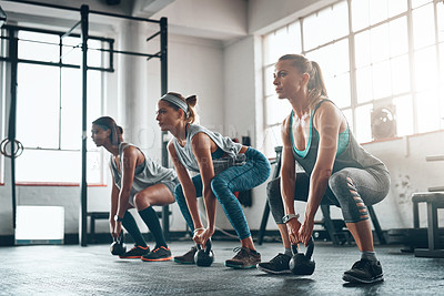 Buy stock photo Shot of three young women working out together