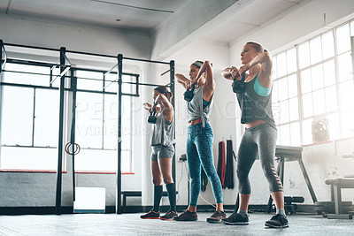Buy stock photo Shot of three young women working out together