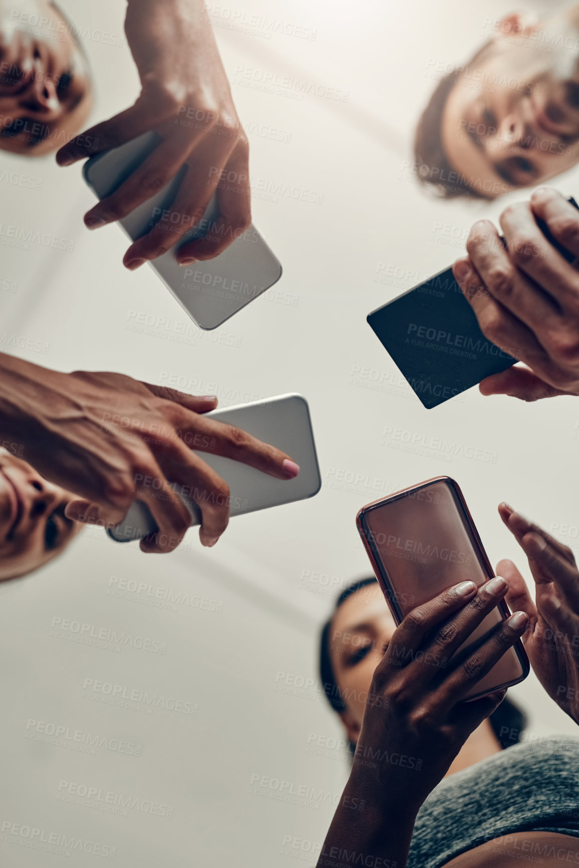 Buy stock photo People, hands and below with phone for fitness schedule, workout or data sync at gym. Low angle, closeup or group on mobile smartphone for training day, exercise routine or networking at health club