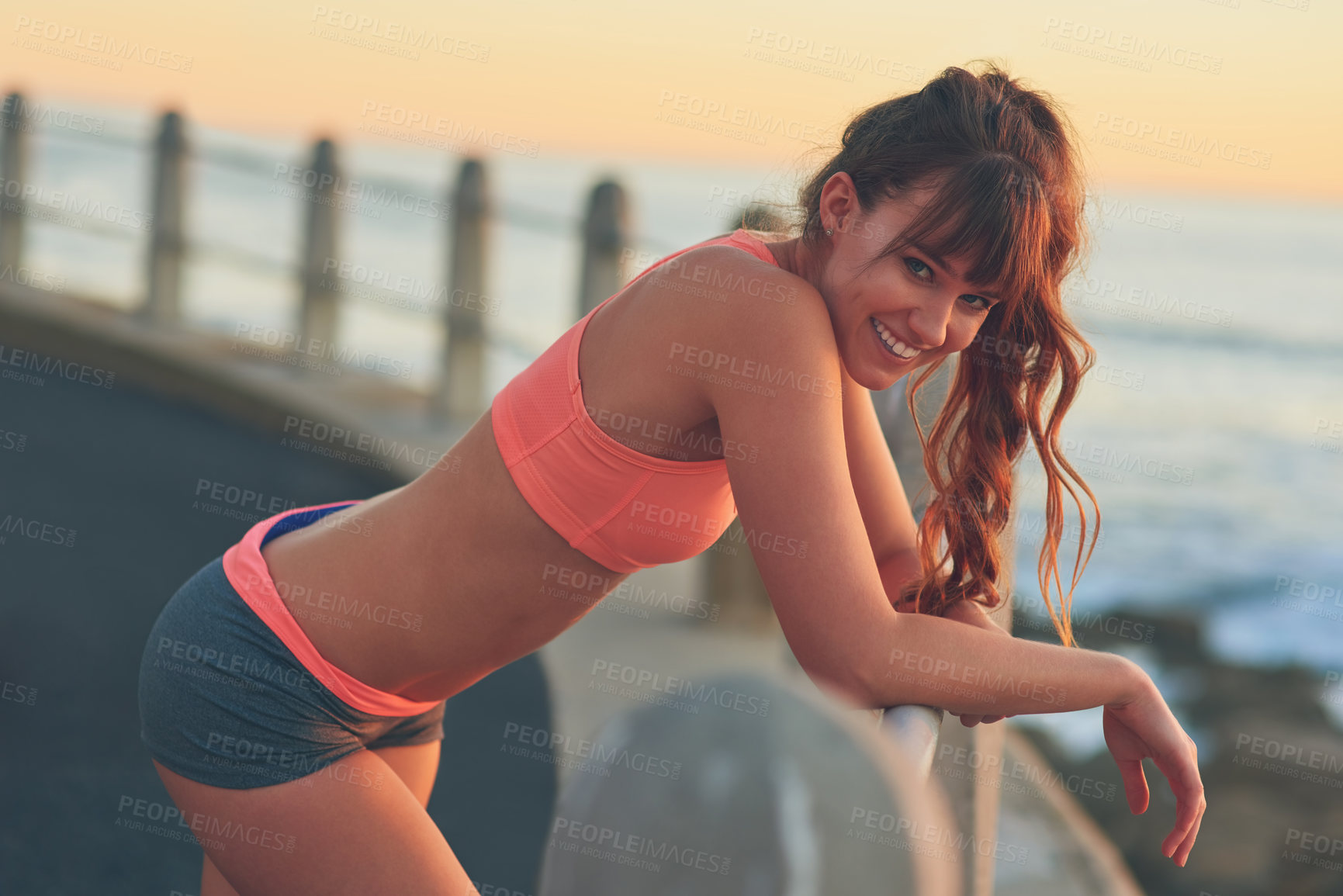 Buy stock photo Fitness, portrait and smile with happy woman on promenade outdoor for break from workout routine. Exercise, health and view with tired sports person at beach to relax or rest from cardio training