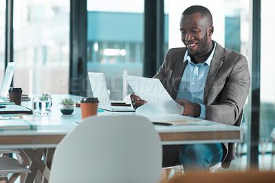 Buy stock photo Cropped shot of a young businessman working at his desk