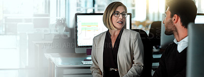 Buy stock photo Shot of two businesspeople having a discussion in an open office