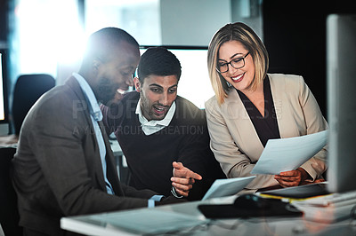 Buy stock photo Shot of two businesspeople discussing paperwork