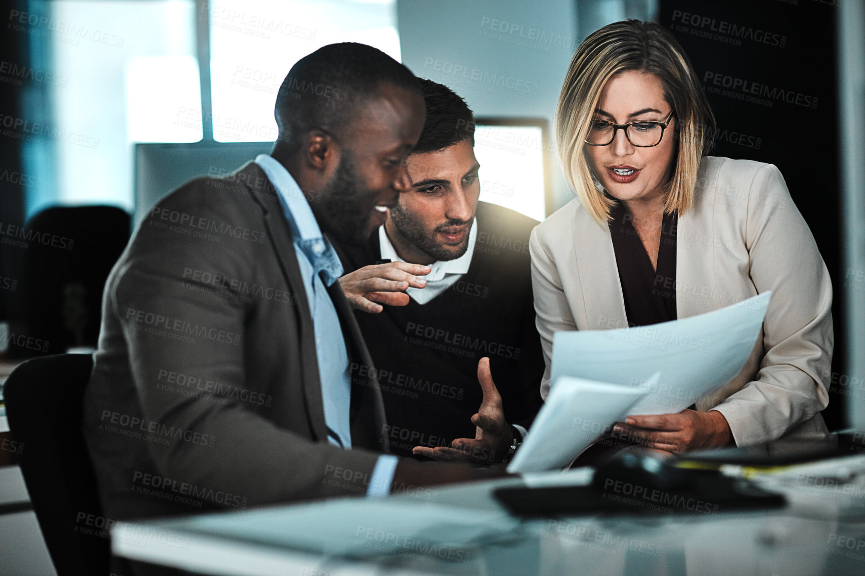 Buy stock photo Shot of two businesspeople discussing paperwork