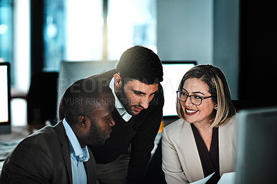 Buy stock photo Shot of three businesspeople working together on a project in an open space