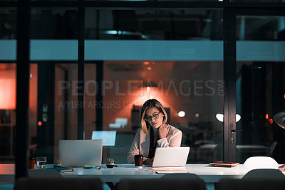 Buy stock photo Shot of a businesswoman suffering from tension during a late night at work