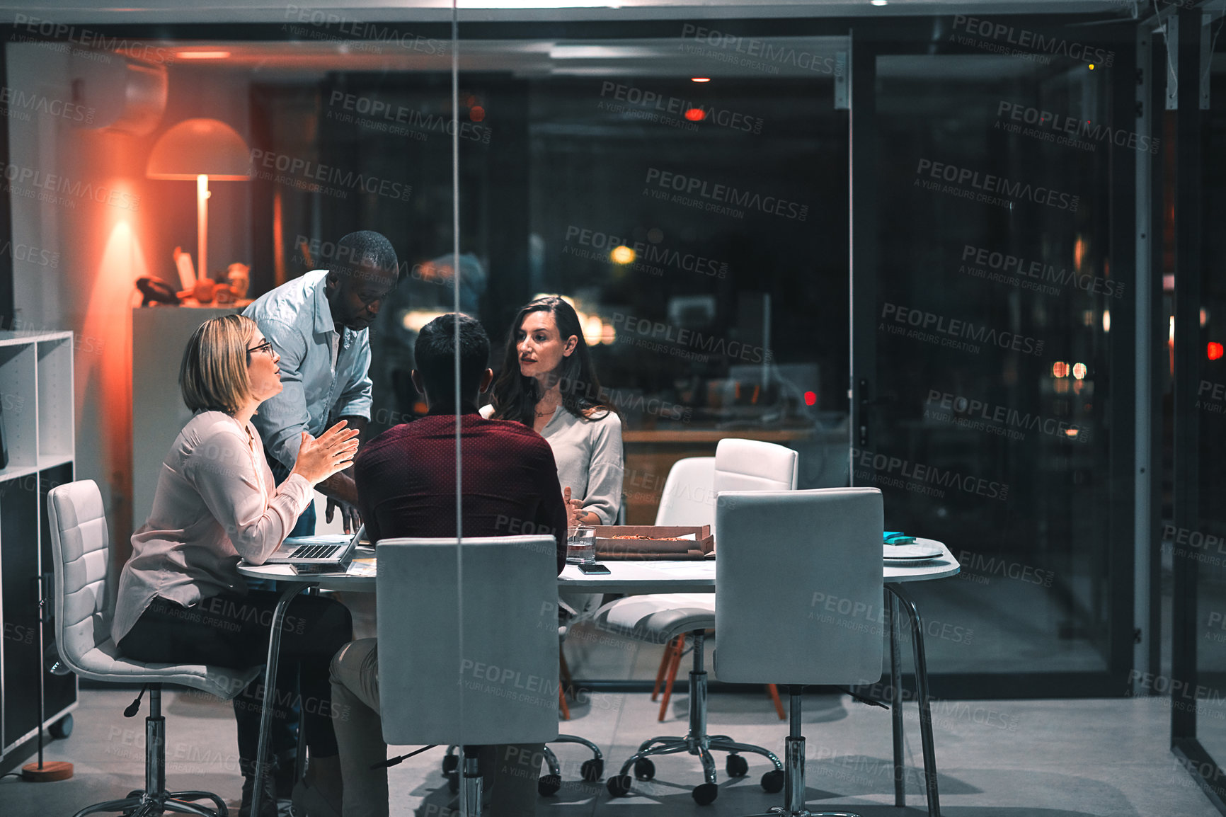 Buy stock photo Business people, laptop and teamwork for design at night in office, creative agency and project overtime. Planning, support and problem solving in research meeting for deadline and discussion