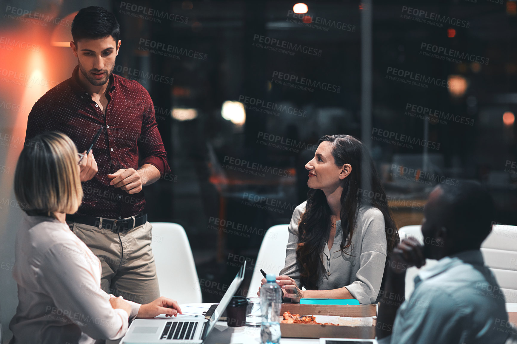 Buy stock photo Business people, laptop and teamwork for project at night in office, creative agency and overtime food for design. Planning, support and problem solving in pizza meeting for deadline and discussion