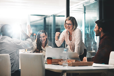 Buy stock photo Shot of colleagues celebrating during a meeting in a modern office