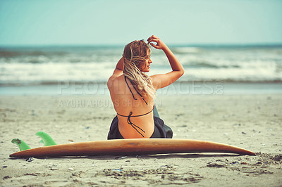 Buy stock photo Shot of a beautiful young woman going for a surf at the beach