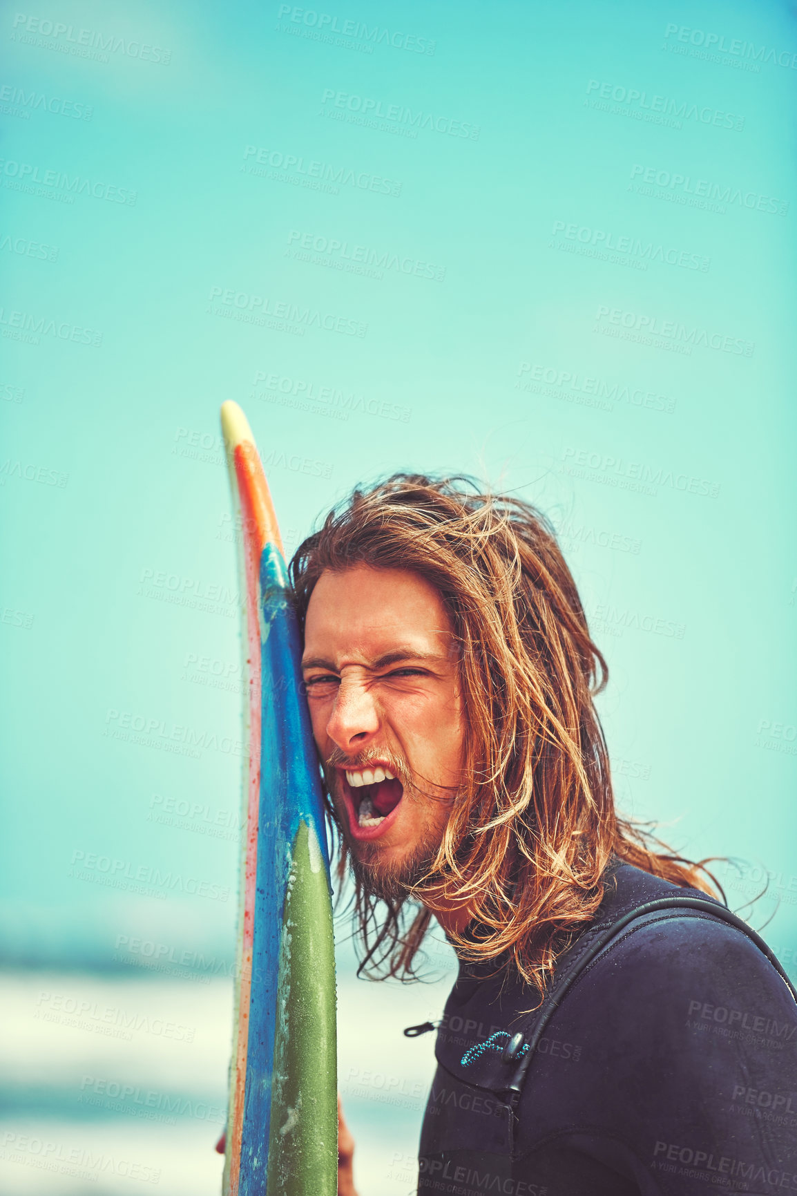 Buy stock photo Cropped shot of a young surfer leaning against his surfboard