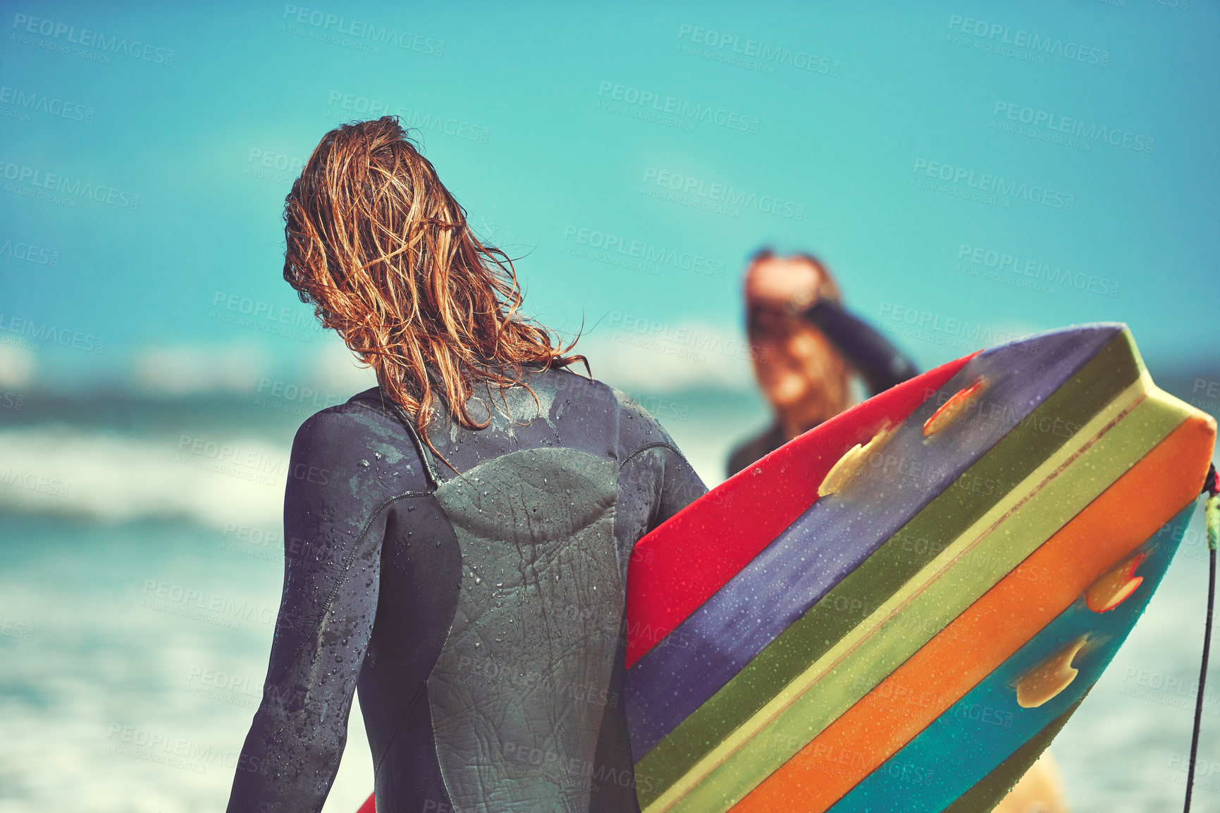 Buy stock photo Shot of a young couple surfing at the beach