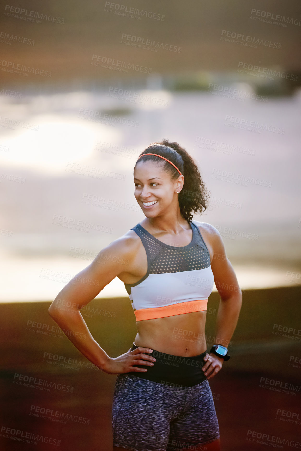 Buy stock photo Cropped shot of an attractive young woman taking a run through the city