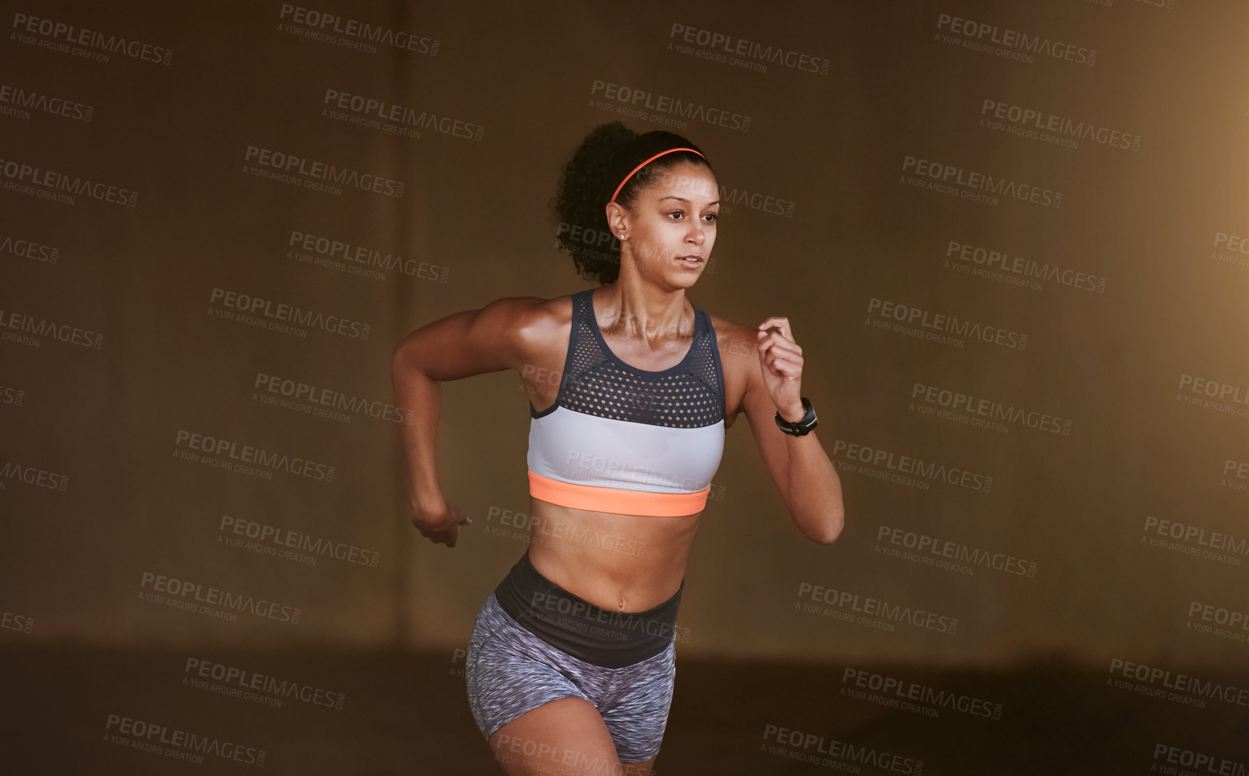 Buy stock photo Cropped shot of an attractive young woman taking a run through the city