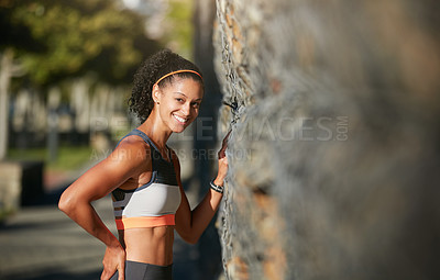 Buy stock photo Cropped portrait of an attractive young woman taking a run through the city