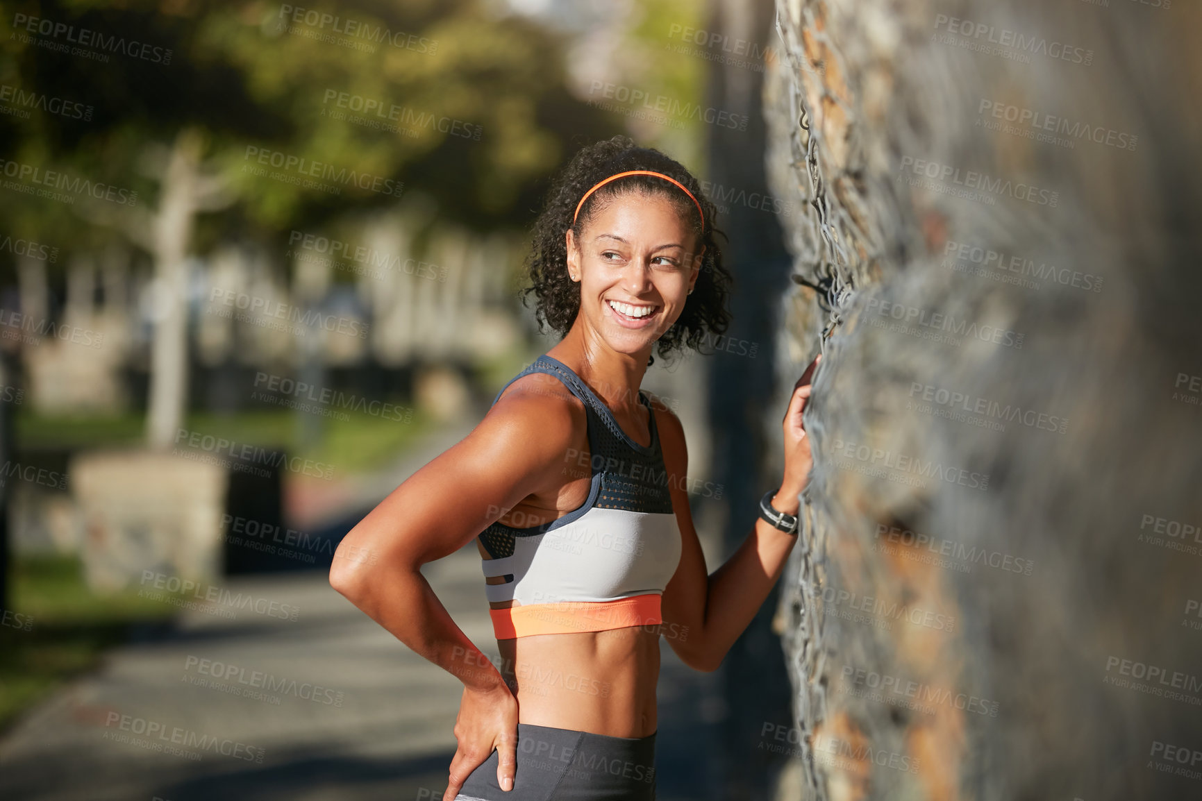 Buy stock photo Cropped shot of an attractive young woman taking a run through the city