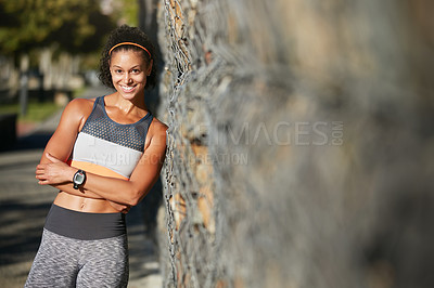 Buy stock photo Cropped portrait of an attractive young woman taking a break from her morning run
