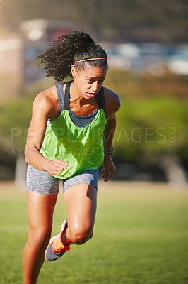 Buy stock photo Shot of a sporty young woman exercising outdoors