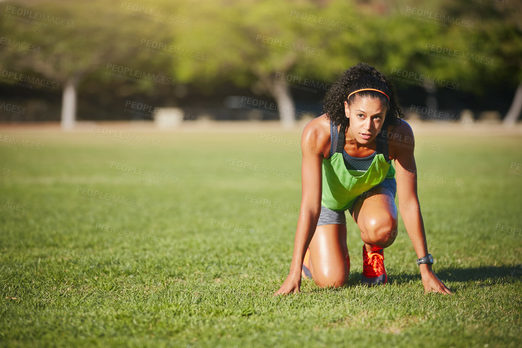 Buy stock photo Shot of a sporty young woman exercising outdoors