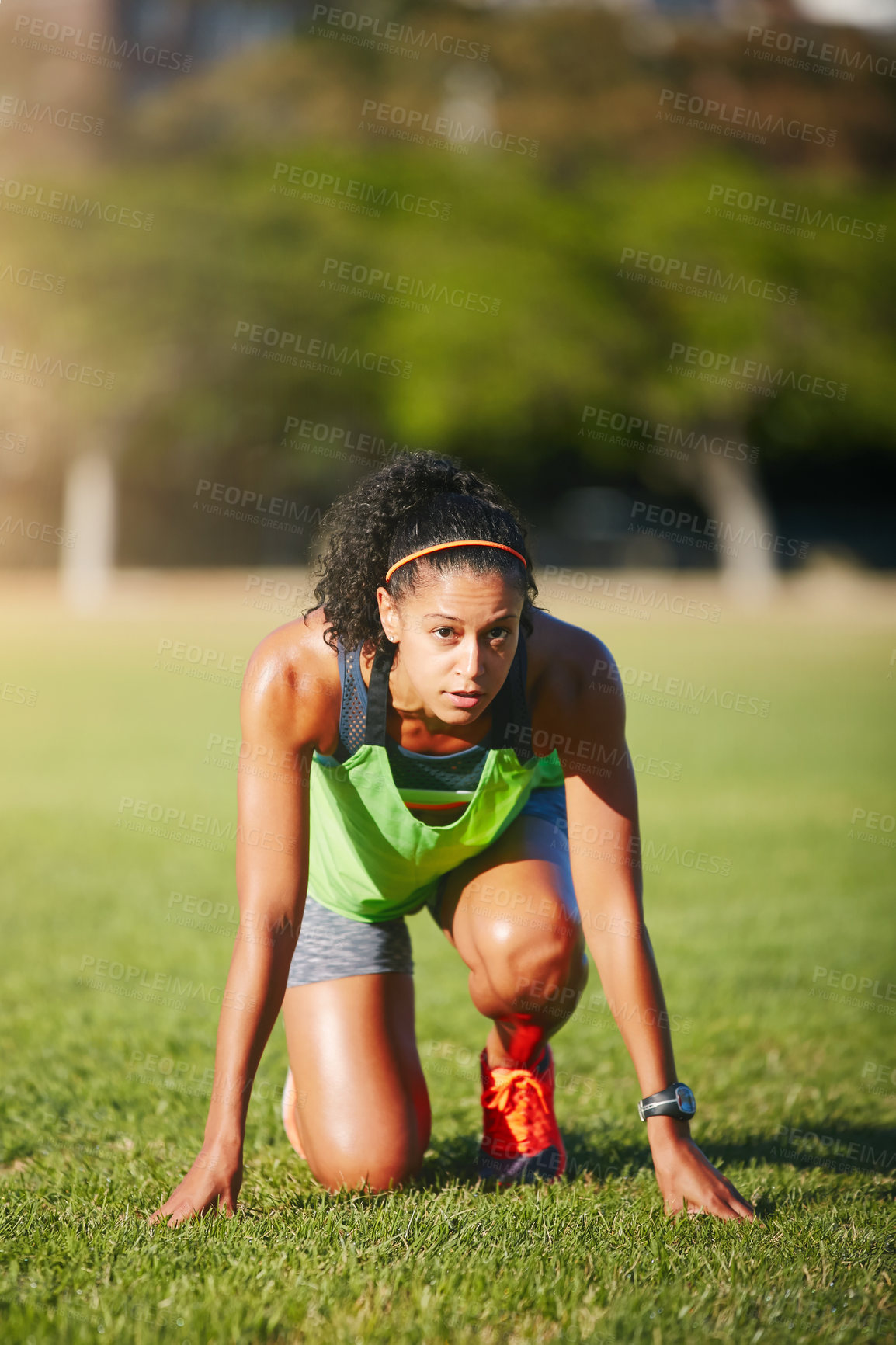 Buy stock photo Shot of a sporty young woman exercising outdoors