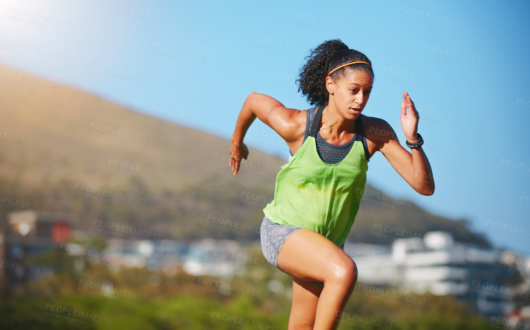 Buy stock photo Shot of a sporty young woman exercising outdoors