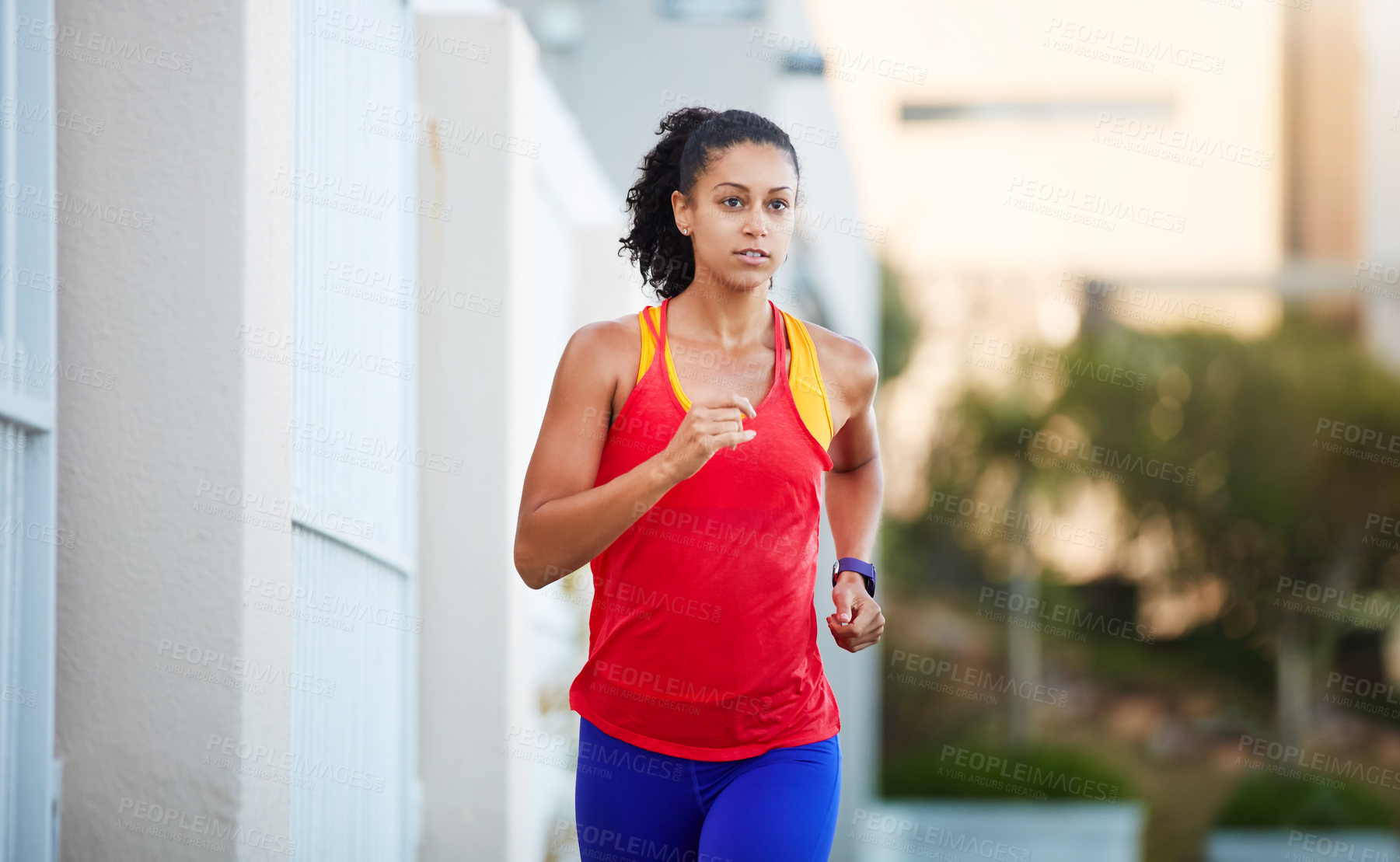 Buy stock photo Shot of a sporty young woman out running in the city by herself