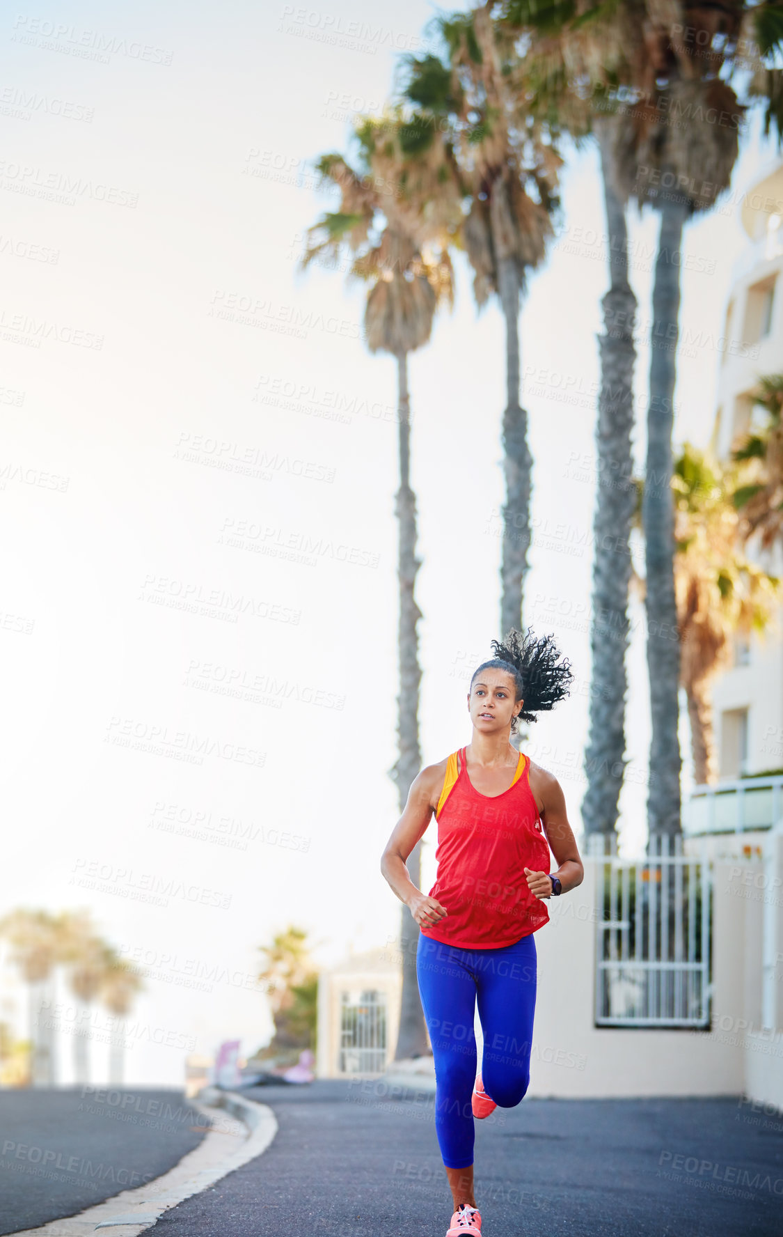 Buy stock photo Shot of a sporty young woman out running in the city by herself