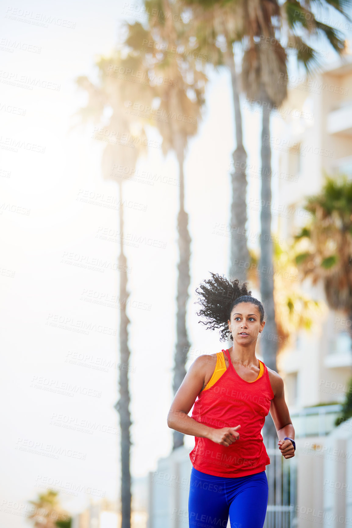 Buy stock photo Shot of a sporty young woman out running in the city by herself