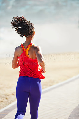 Buy stock photo Shot of a sporty young woman out for her morning run