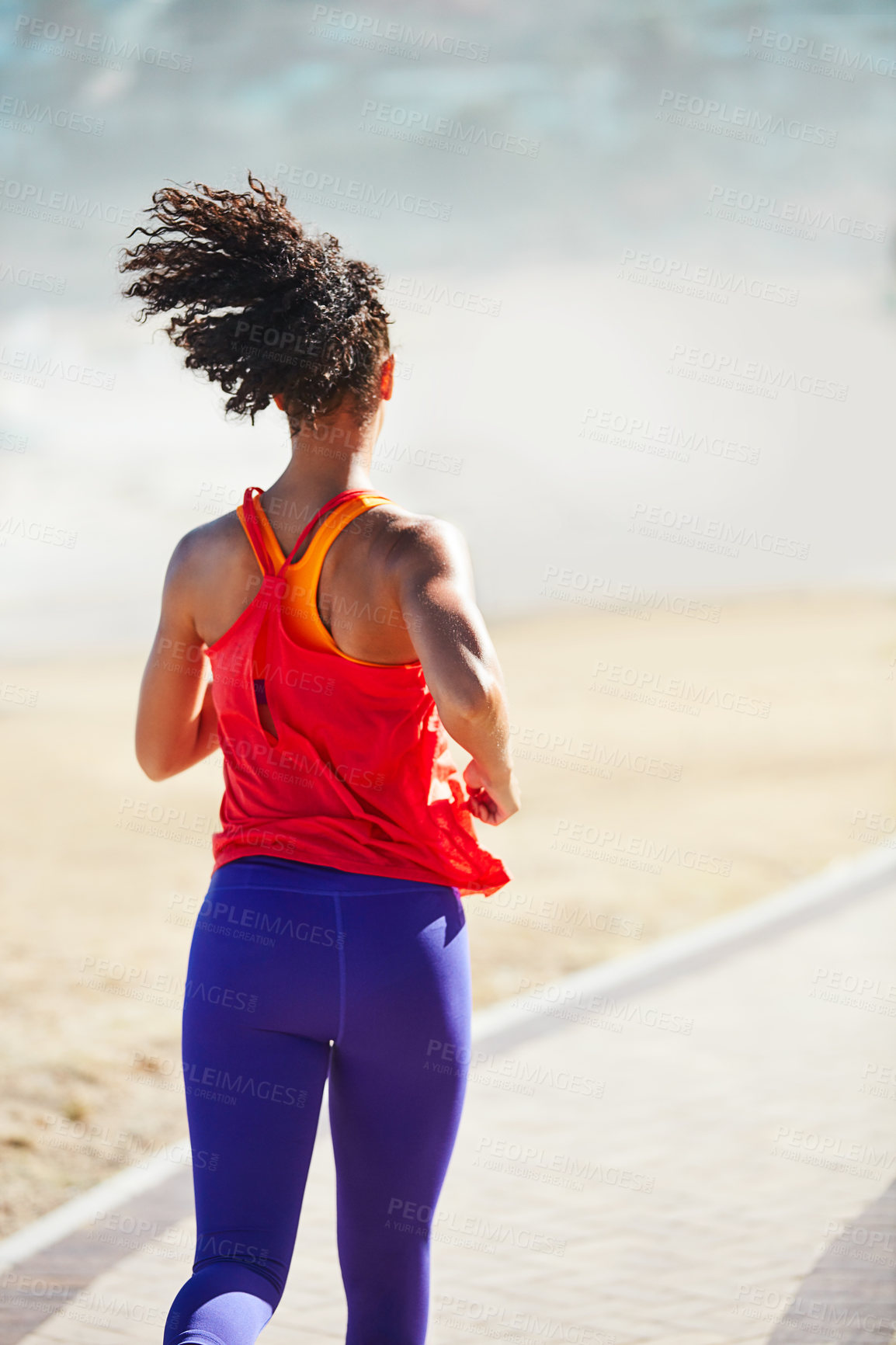 Buy stock photo Shot of a sporty young woman out for her morning run