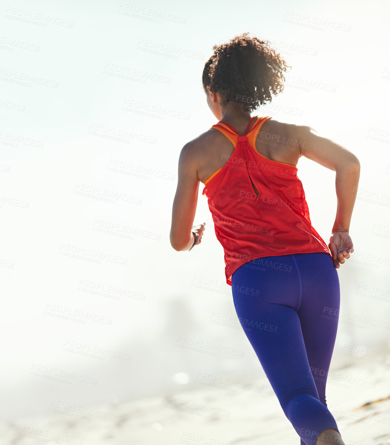 Buy stock photo Shot of a sporty young woman out for her morning run