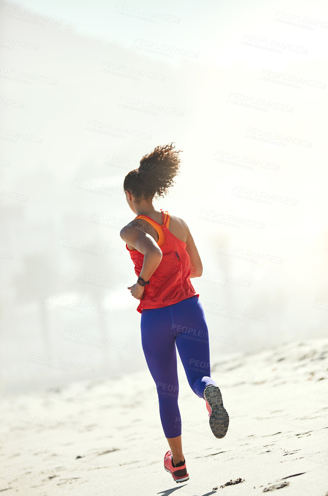 Buy stock photo Shot of a sporty young woman out for her morning run