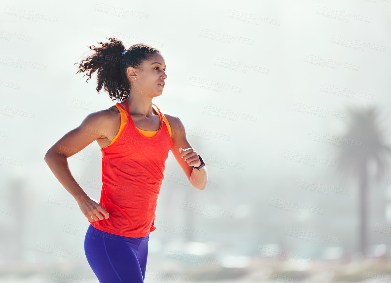 Buy stock photo Shot of a sporty young woman out for her morning run