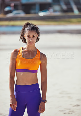 Buy stock photo Shot of a sporty young woman standing outside after her morning workout